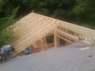 Framing a new roof addition that ties into an existing shingle roof in Westbury