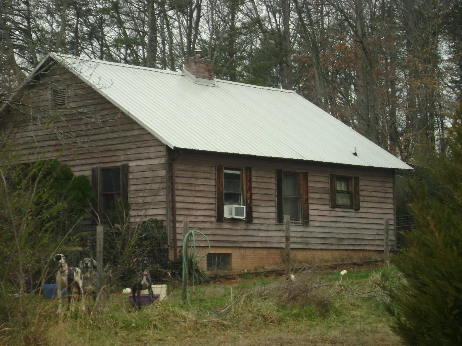 White metal roof on an old wood sided farmhouse, from a Metal Roof Installation job in Westbury